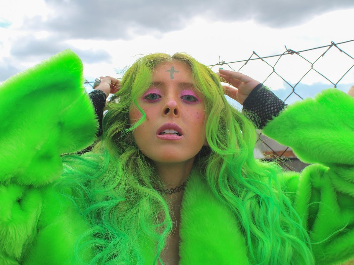 A woman with vivid green wavy hair